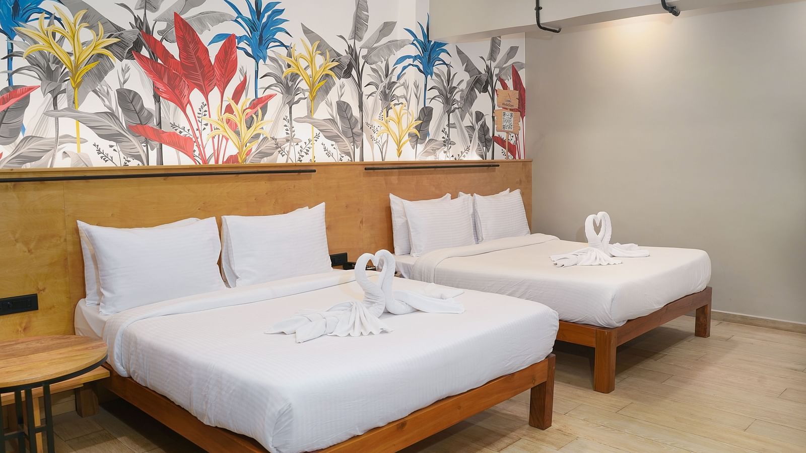 A large bed placed next to another bed in Urban Corner Room at Indie Stays Resort, Goa